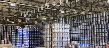 Image shows a warehouse full of kegs ready to be collected